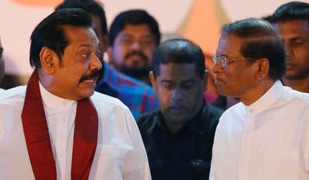 FILE PHOTO: Sri Lanka's newly appointed Prime Minister Mahinda Rajapaksa talks with President Maithripala Sirisena during a rally near the parliament in Colombo, Sri Lanka November 5, 2018. REUTERS/Dinuka Liyanawatte