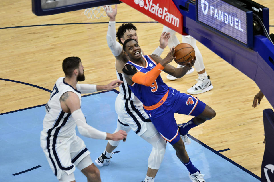 New York Knicks guard RJ Barrett (9) shoots ahead of Memphis Grizzlies center Jonas Valanciunas (17) and forward Dillon Brooks in the second half of an NBA basketball game Monday, May 3, 2021, in Memphis, Tenn. (AP Photo/Brandon Dill)