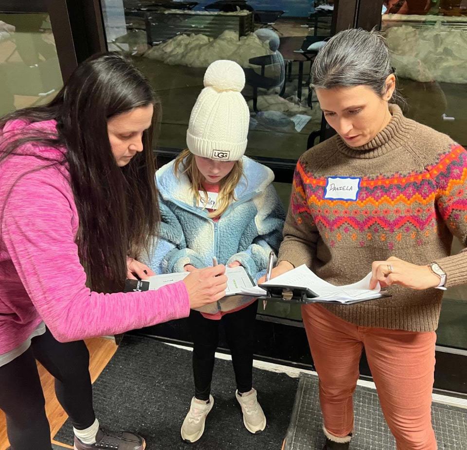 Organization is important as Heather Bryan, Bailey McIlwaine and Daniela Oliveira assign cots at Fig Tree Knoxville during the snowstorm Tuesday, Jan. 16, 2024.