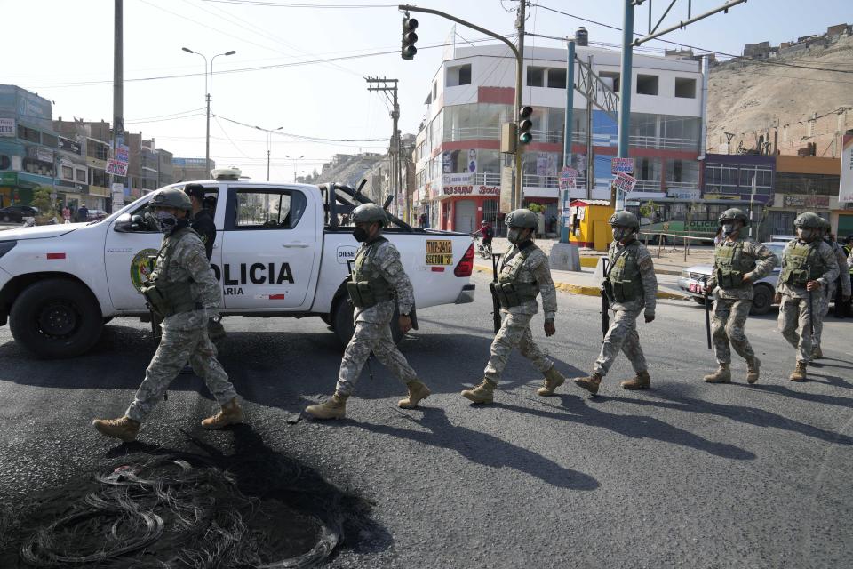 Special Forces Police arrive to a checkpoint in the Manchay district, on the outskirts of Lima, Peru, Tuesday, April 5, 2022. Peru’s President Pedro Castillo imposed a curfew on the capital and the country’s main port in response to sometimes violent protests over rising prices of fuel and food, requiring people in Lima and Callao to mostly stay in their homes all of Tuesday. (AP Photo/Martin Mejia)