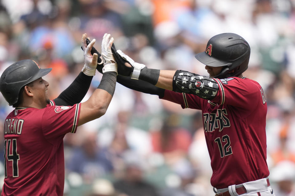 Arizona Diamondbacks designated hitter Lourdes Gurriel Jr. is greeted by Gabriel Moreno after hitting a three-run home run during the fifth inning of a baseball game against the Detroit Tigers, Saturday, June 10, 2023, in Detroit. (AP Photo/Carlos Osorio)