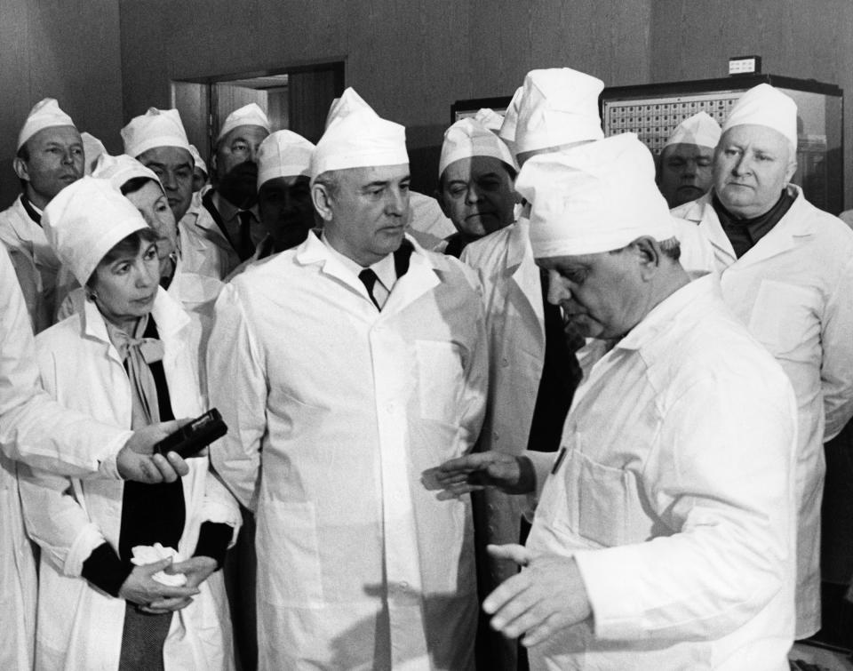 Soviet leader Mikhail Gorbachev (C) and his wife Raisa Gorbachev (2nd L) talk with officials at the Chernobyl nuclear power plant on February 23, 1989.<span class="copyright">V. Samokhotsky—AFP via Getty Images</span>