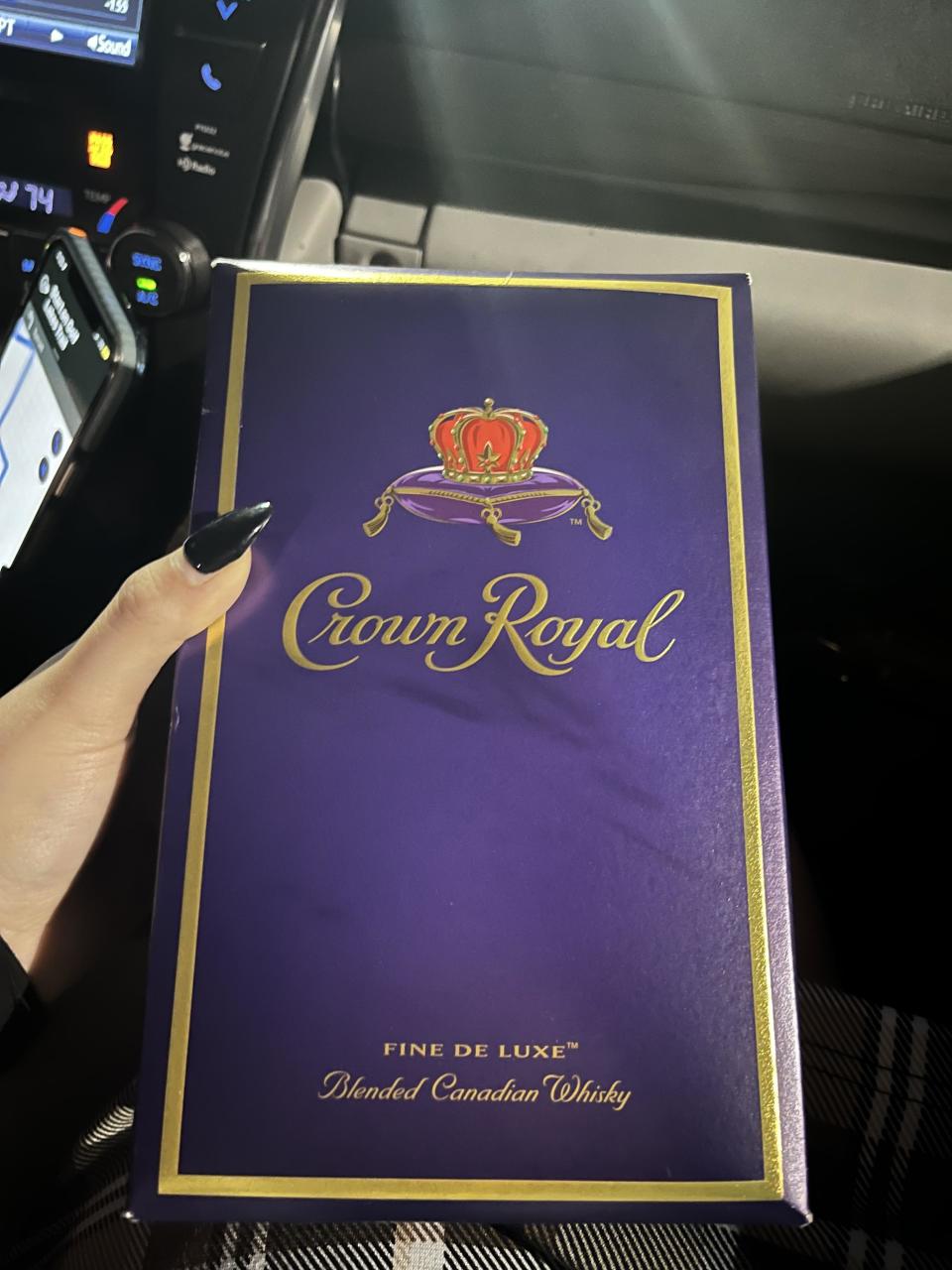 person holding crown royal box