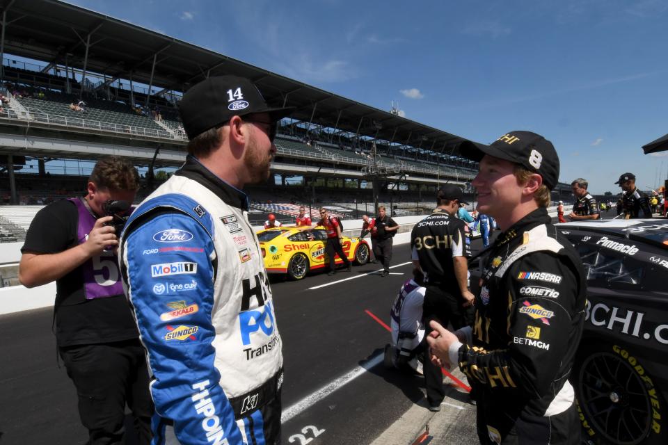 NASCAR Cup Series driver Chase Briscoe (14) talks with NASCAR Cup Series driver Tyler Reddick (8) on Saturday, July 30, 2022, during qualifying for the Verizon 200 at the Brickyard at Indianapolis Motor Speedway.