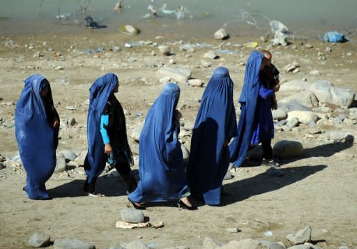 File photo of Afghan women in a park in Kabul. Afghan President Hamid Karzai has ordered the release of a woman who was jailed for adultery after being raped following outcry over the case. However, the woman now faces having to marry her attacker