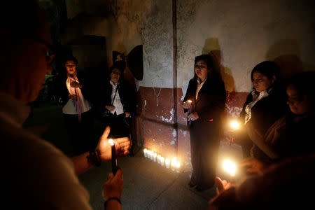 Candles are lit during a vigil for victims after a fire broke at the Virgen de Asuncion home in San Jose Pinula on the outskirts of Guatemala City, March 8, 2017. REUTERS/Saul Martinez