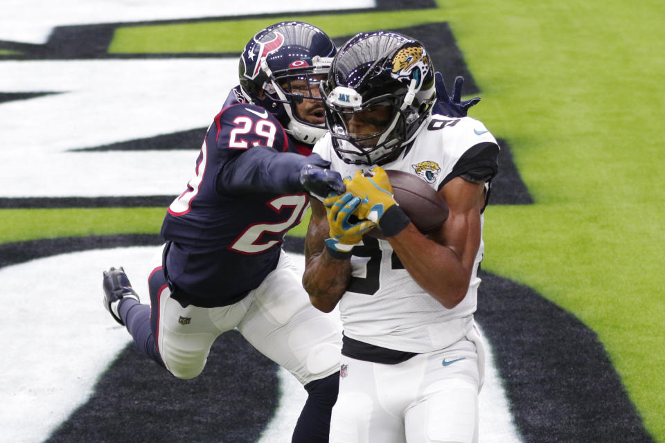 Jacksonville Jaguars wide receiver Keelan Cole (84) catches a pass over Houston Texans cornerback Phillip Gaines (29) for a touchdown during the first half of an NFL football game Sunday, Oct. 11, 2020, in Houston. (AP Photo/Michael Wyke)