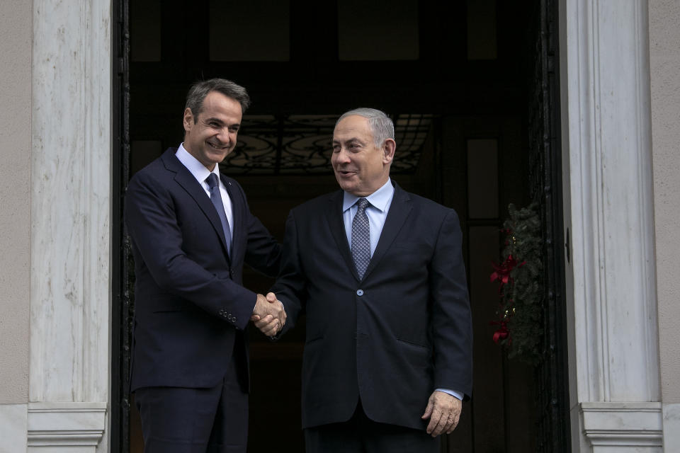 Greece's Prime Minister Kyriakos Mitsotakis, left, welcomes his Israeli counterpart Benjamin Netanyahu in Athens, Thursday, Jan. 2, 2020. The leaders of Greece, Israel and Cyprus will meet in Athens Thursday to sign a deal aiming to build a key undersea pipeline, named EastMed, designed to carry gas from new rich offshore deposits in the southeastern Mediterranean to continental Europe.(AP Photo/Yorgos Karahalis)