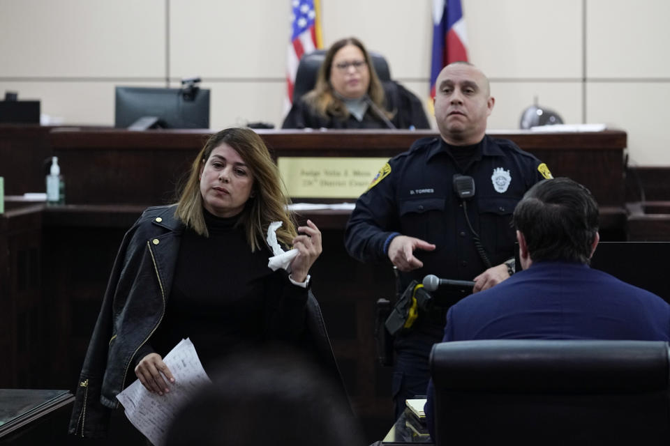 Irma Reyes, left, leaves Judge Velia Meza's court after she was allowed to make a statement, Monday, Jan. 23, 2023, in San Antonio. Reyes' daughter was one of two teens who men were accused of keeping at a San Antonio motel where other men paid to have sex with them in 2017. Their cases have seen years of delay, a parade of prosecutors, an aborted trial and, ultimately, a stark retreat by the government with the offer of a plea deal. (AP Photo/Eric Gay)