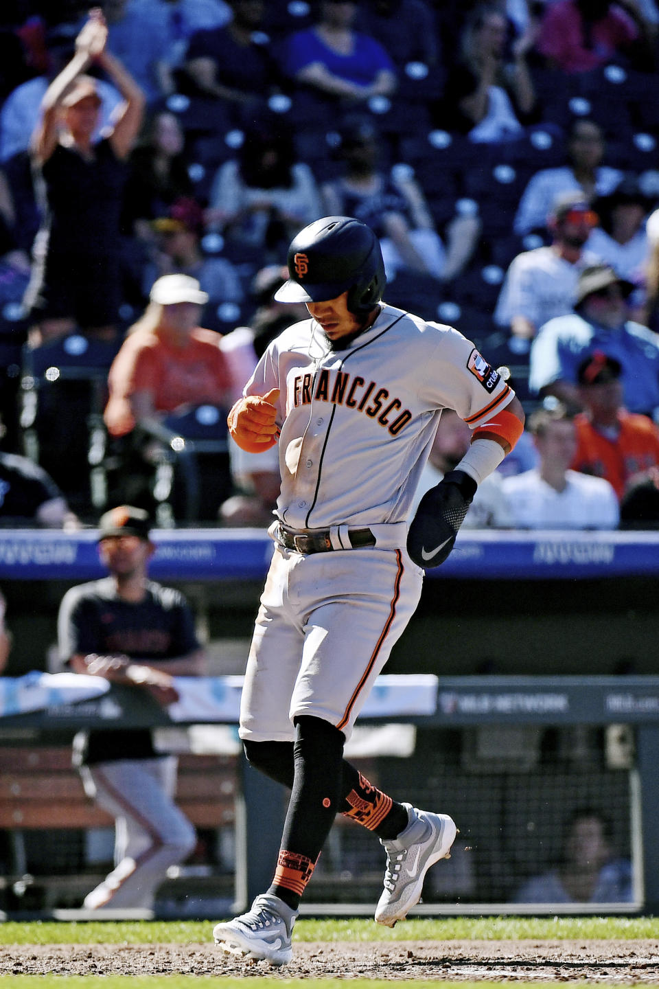 San Francisco Giants' Thairo Estrada scores in the sixth inning of a baseball game against the Colorado Rockies, Sunday, Sept. 17, 2023, in Denver. (AP Photo/Geneva Heffernan)