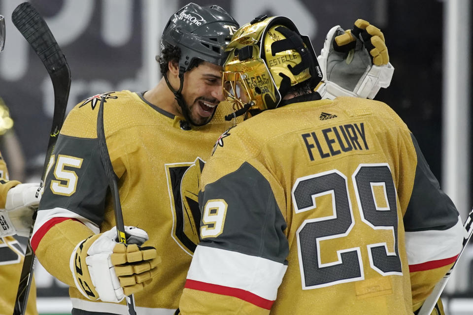 Vegas Golden Knights right wing Ryan Reaves, left, celebrates with goaltender Marc-Andre Fleury (29) after defeating the Colorado Avalanche in an NHL hockey game Sunday, Feb. 14, 2021, in Las Vegas. (AP Photo/John Locher)