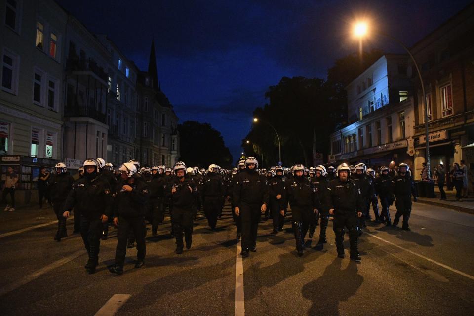 <p>Riot police walk down a road during the “Welcome to Hell” protest march on July 6, 2017 in Hamburg, Germany. Leaders of the G20 group of nations are arriving in Hamburg today for the July 7-8 economic summit and authorities are bracing for large-scale and disruptive protest efforts tonight at the “Welcome to Hell” anti-G20 protest. (Photo: Leon Neal/Getty Images) </p>