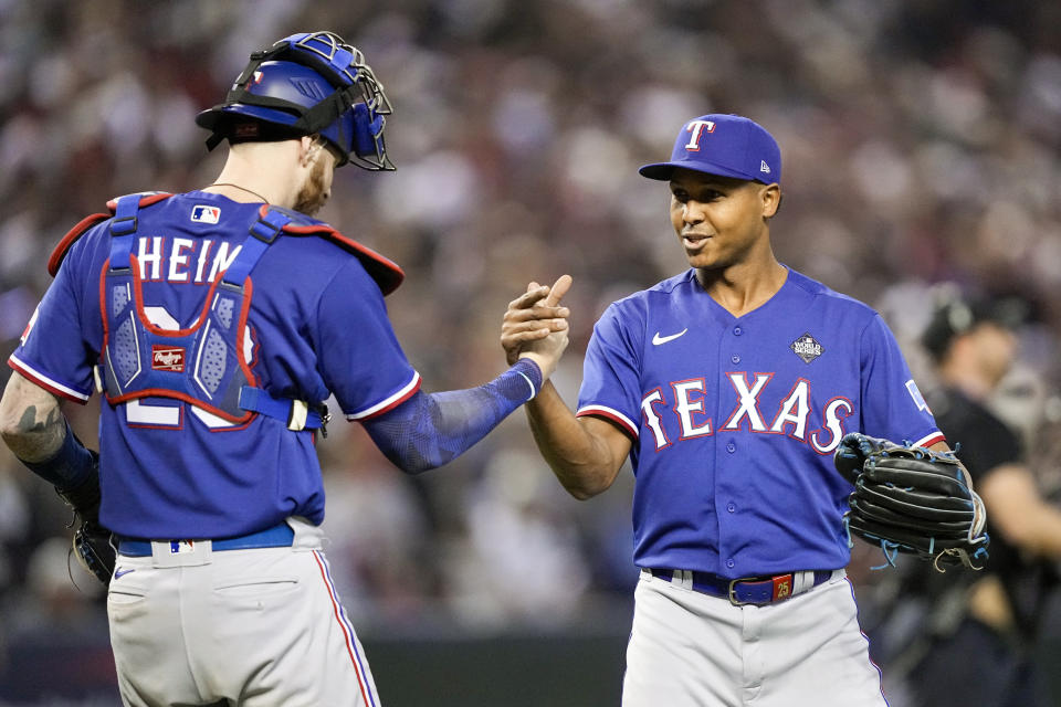 Texas Rangers relief pitcher Jose Leclerc and catcher Jonah Heim celebrate their win against the Arizona Diamondbacks in Game 3 of the baseball World Series Monday, Oct. 30, 2023, in Phoenix. (AP Photo/Brynn Anderson)