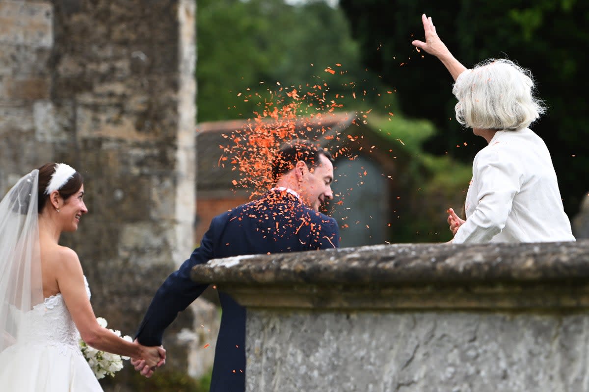 The newlyweds were showered in orange confetti (Getty Images)