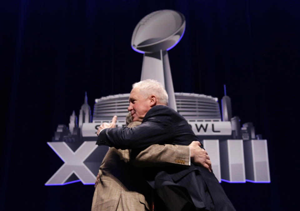 Seattle Seahawks head coach Pete Carroll and Denver Broncos head coach John Fox, right, hug each other after speaking to the media at a news conference Friday, Jan. 31, 2014, in New York. The Seahawks and the Broncos are scheduled to play in the NFL Super Bowl XLVIII football game on Sunday, Feb. 2, at MetLife Stadium in East Rutherford, N.J. (AP Photo/Matt Slocum)