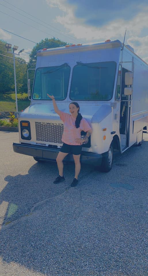 Hannah Lemieux poses with the new food truck she purchased in August.