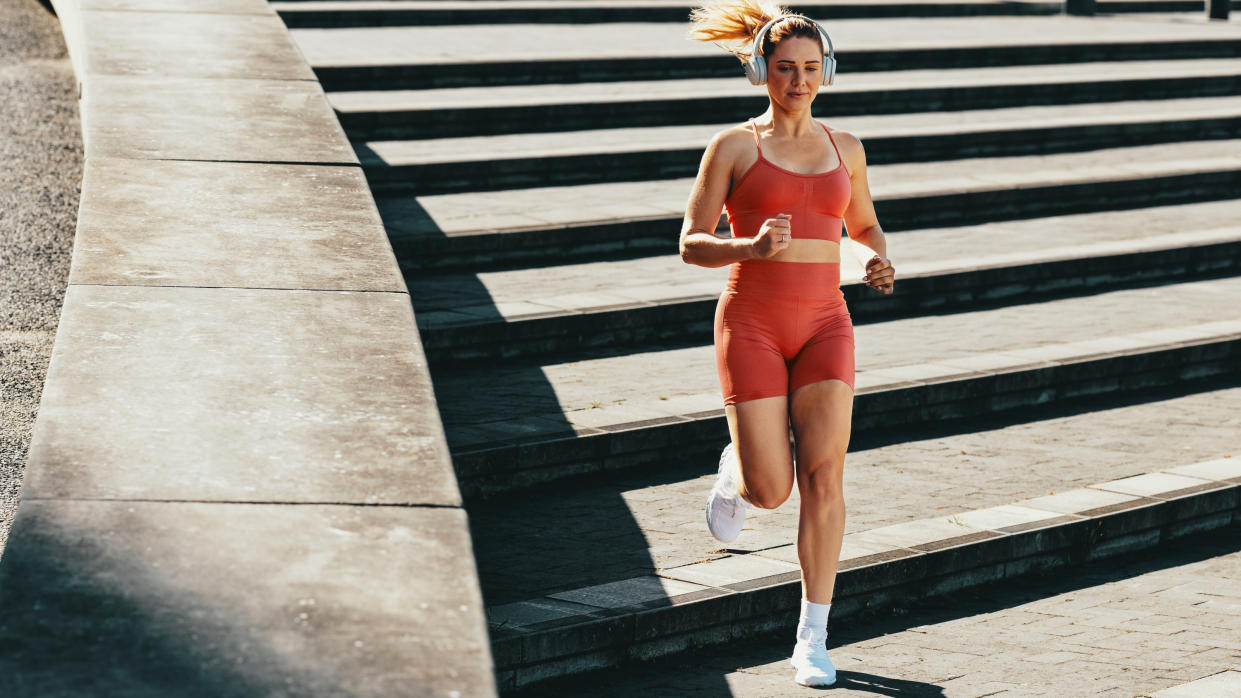  A photo of a woman running down a set of steps. 