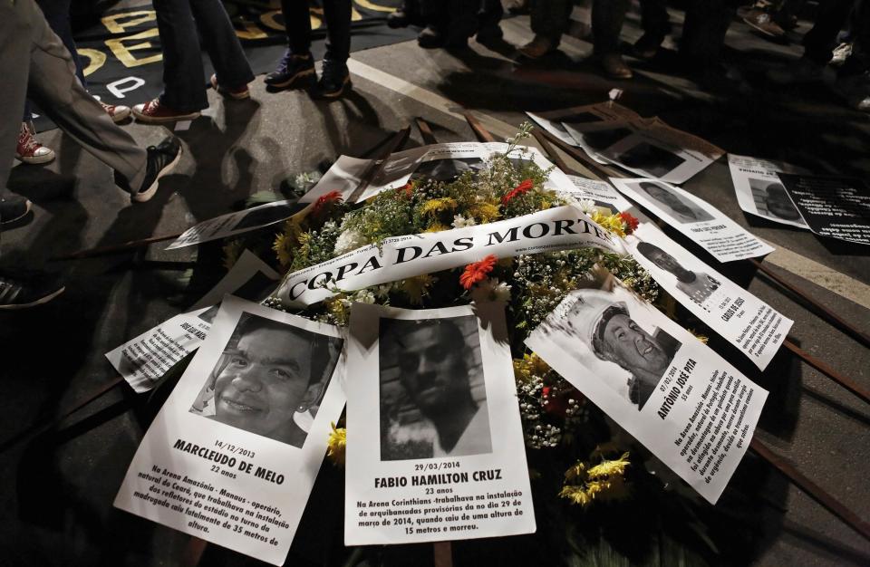 Flowers with pictures of dead workers are seen during protest against the 2014 World Cup, in Sao Paulo