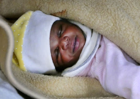 A migrant baby girl is seen sleeping aboard the former fishing trawler Golfo Azzurro, about thirty-two hours after her rescue along other migrants from their drifting plastic rafts by Spanish NGO Proactiva Open Arms, in the Mediterranean Sea, off the Libyan coast April 2, 2017. REUTERS/Yannis Behrakis