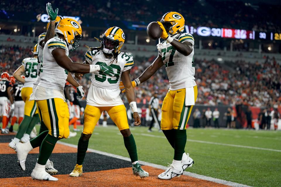 Green Bay Packers running back Emanuel Wilson (31) is congratulated after scoring a touchdown in the third quarter during a preseason game against the Cincinnati Bengals.