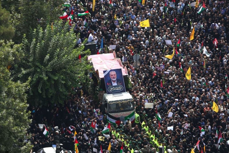 Iranians follow a truck carrying the coffins of Hamas leader Ismail Haniyeh and his bodyguard,  who were assassinated in the Iranian Capital, during their funeral ceremony. Iranian Supreme Leader's Office/ZUMA Press Wire/dpa