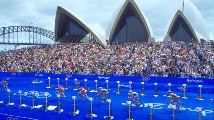 The women pass by the Sydney Opera House in the 2000 Olympic triathlon. Photo: Jamie Squire/Allsport