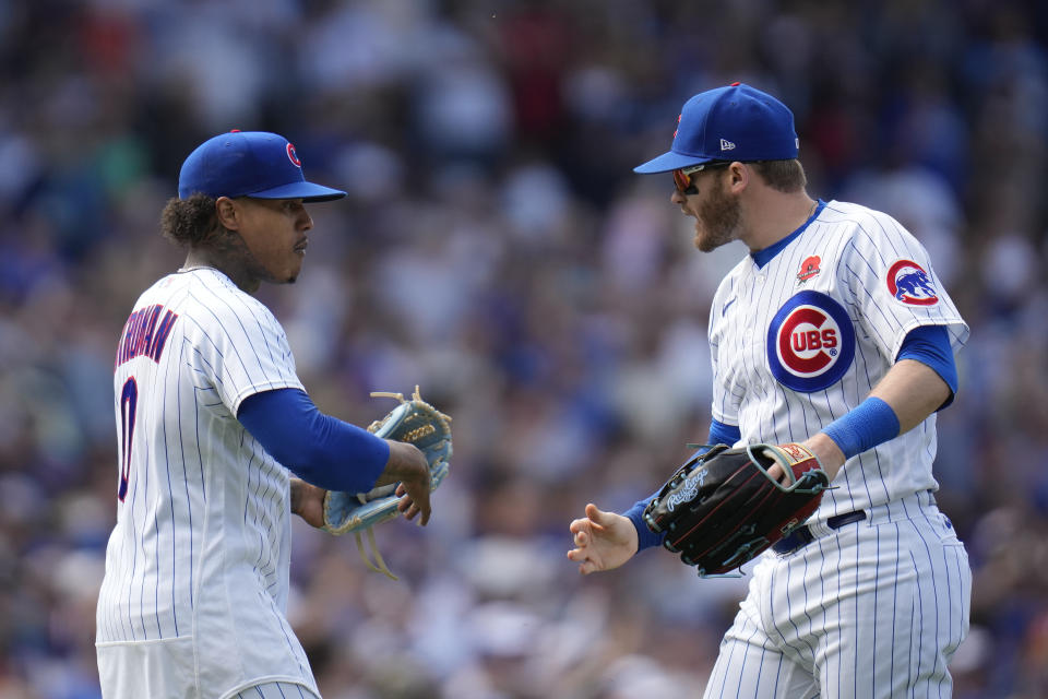 Chicago Cubs starting pitcher Marcus Stroman, left, slaps hands with Ian Happ after pitching an entire baseball game against the Tampa Bay Rays, Monday, May 29, 2023, in Chicago. (AP Photo/Erin Hooley)