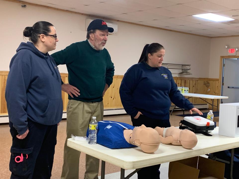 Jim White (center) stands with EMS staff during a demonstration of how to use automated external defibrillators on Friday, Feb. 24 at the Boyne City Eagles Lodge.