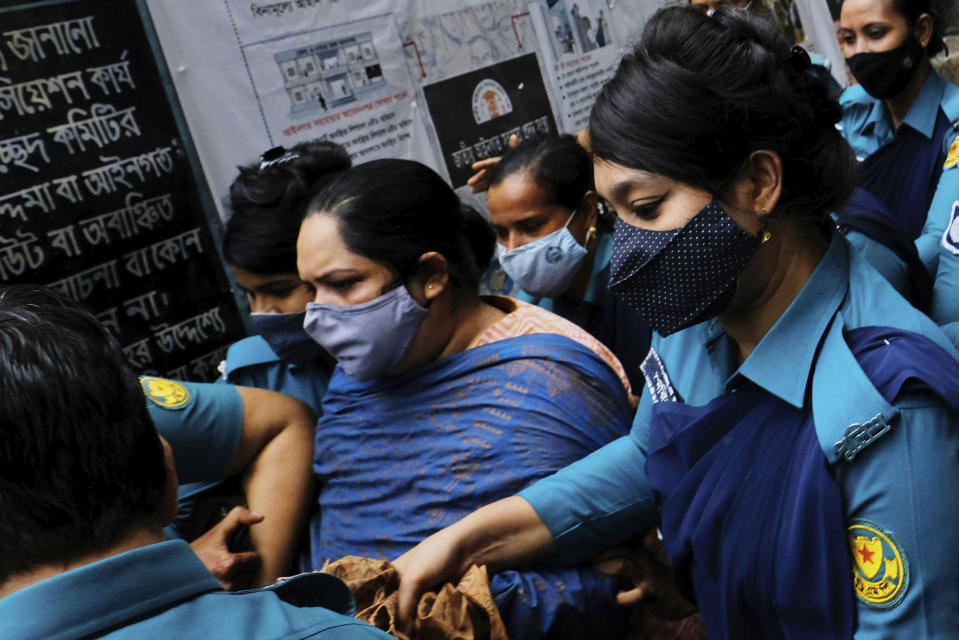 Bangladeshi journalist Rozina Islam, center, is escorted by police to a court in Dhaka, Bangladesh, Tuesday, May 18, 2021. Police in Bangladesh's capital have arrested the prominent journalist on charges of stealing and photographing sensitive state information. (AP Photo/Mahmud Hossain Opu)