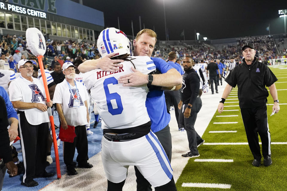 SMU head coach Rhett Lashlee hugs defensive tackle Jordan Miller (6) during the second half of the American Athletic Conference championship NCAA college football game against Tulane, Saturday, Dec. 2, 2023 in New Orleans. SMU won 26-14. (AP Photo/Gerald Herbert)