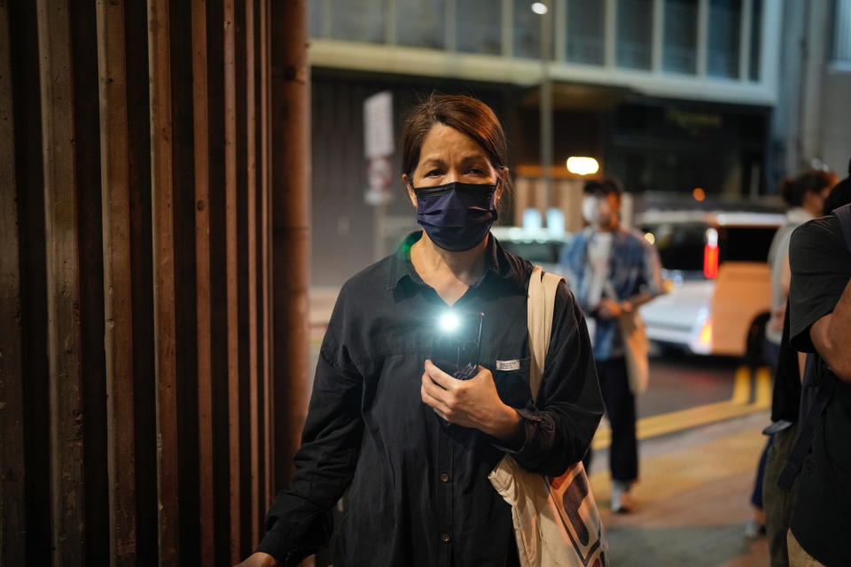 Pro-democracy protester holds an illuminated cell phone near Hong Kong's Victoria Park, Saturday, June 4, 2022. Dozens of police patrolled Hong Kong’s Victoria Park on Saturday after authorities for a third consecutive year banned public commemoration of the anniversary of the deadly Tiananmen Square crackdown in 1989, with vigils overseas the only place marking the event. (AP Photo/Kin Cheung)