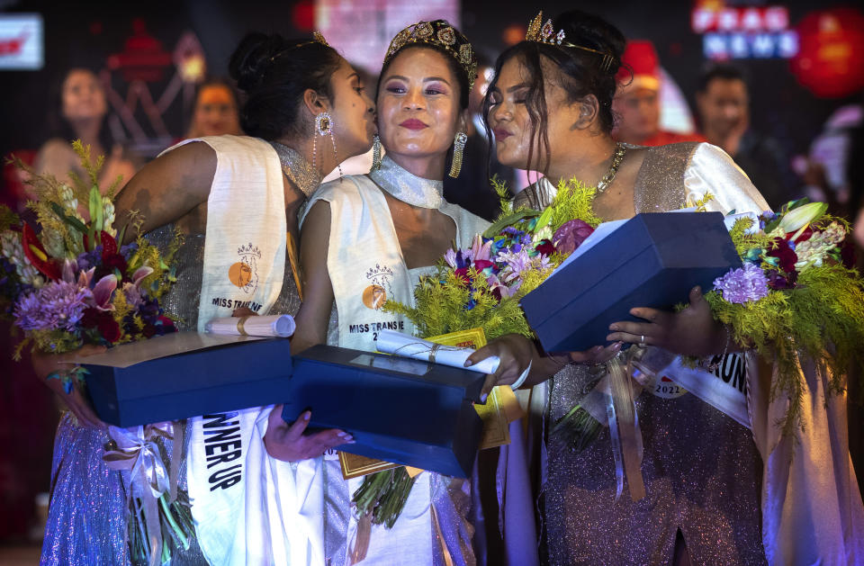 Winner of Miss Trans Northeast 22, Lucey Ham, center, with first runner-up Aria Deka, right, and Rishidhya Sangkarishan as second runner up pose for a photograph in Guwahati, India, Wednesday, Nov. 30, 2022. In a celebration of gender diversity and creative expression, a beauty pageant in eastern Indian state of Assam brought dozens of transgender models on stage in Guwahati. Sexual minorities across India have gained a degree of acceptance especially in big cities and transgender people were given equal rights as a third gender in 2014. But prejudice against them persists and the community continues to face discrimination and rejection by their families. (AP Photo/Anupam Nath)