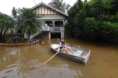 Local resident Lennon Bartlett paddles a rowboat through floodwaters in the northern New South Wales town of Lismore, Australia, March 31, 2017 after heavy rains associated with Cyclone Debbie swelled rivers to record heights across the region. AAP/Dave Hunt/via REUTERS