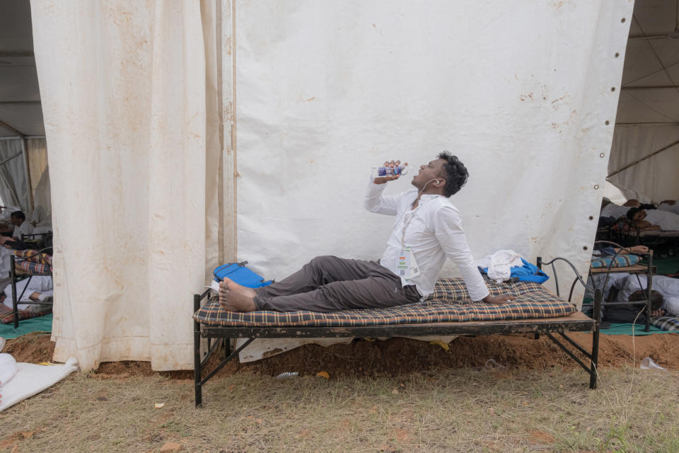 A participant in the Bharat Jodo Yatra rests on a cot near Giriyammanahally village in Karnataka, India, on Oct. 12, 2022.<span class="copyright">Ronny Sen for TIME</span>