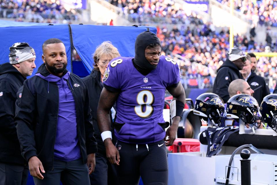 Baltimore Ravens quarterback Lamar Jackson leaves the injury tent and heads toward the locker room.