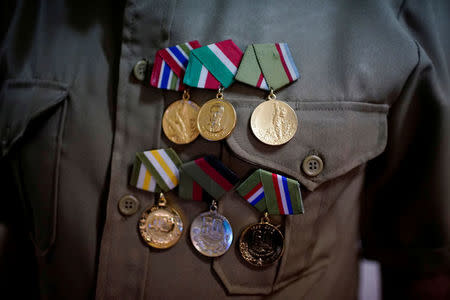 Former rebel Nelson Alvarez, 85, shows his medals in his home in El Cobre, Cuba, April 2, 2018. Picture taken on April 2, 2018. REUTERS/Alexandre Meneghini