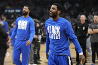 Dallas Mavericks guard Kyrie Irving smiles as he warms up prior to an NBA basketball game against the Los Angeles Clippers Wednesday, Feb. 8, 2023, in Los Angeles. (AP Photo/Mark J. Terrill)