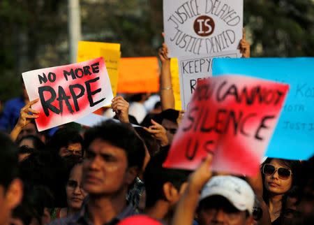 People hold placards as they participate in a protest against the rape of an eight-year-old girl in Kathua near Jammu, and a teenager in Unnao, Uttar Pradesh state, in Mumbai, India, April 15, 2018. REUTERS/Danish Siddiqui