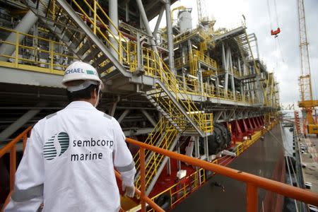 A Sembcorp Marine employee prepares to board Tullow Oil's newly completed Floating Production, Storage and Offloading vessel (FPSO) Prof. John Evans Atta Mills at Sembcorp Marine's Jurong Shipyard in Singapore January 20, 2016. REUTERS/Edgar Su