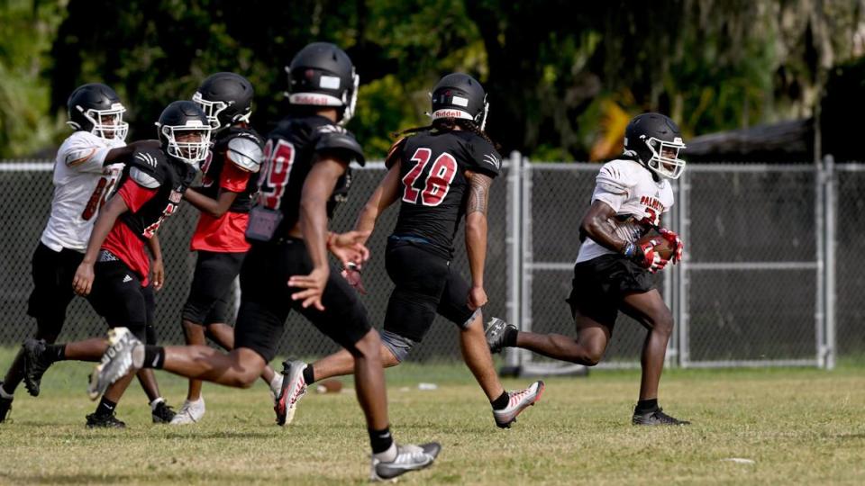 The Palmetto High football team practice at the Palmetto Charter School in the morning to try to beat the heat of the afternoons.