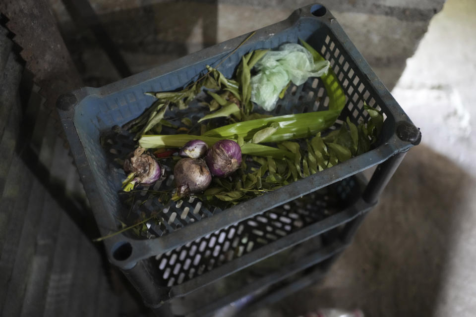 Only available vegetables are seen kept on a kitchen shelf in the house of Lalani, a pregnant mother who also have three children in Vavuniya, about 250 kilometres north east of Colombo, Sri Lanka, Wednesday, Dec. 14, 2022. (AP Photo/Eranga Jayawardena)