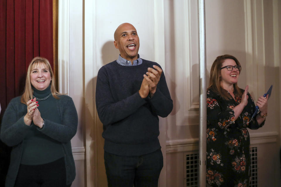 CORRECTS TO SATURDAY, NOT SUNDAY-U.S. Sen. Cory Booker, D-N.J., claps on the sidelines as he waits for his turn to speak at a post-midterm election victory celebration in Manchester, N.H., on Saturday, Dec. 8, 2018. (AP Photo/ Cheryl Senter)