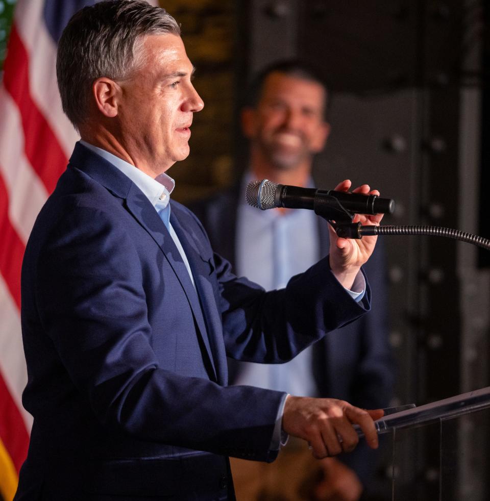 Rep. Jim Banks speaks as Donald Trump Jr. watches in Indianapolis on Monday, Nov. 6, 2023, during a town hall-style meeting to discuss PublicSquare, which dubs itself as an “anti-woke” shopping app. Rep. Jim Banks is seeking a U.S. Senate seat during the Nov. 7 elections.