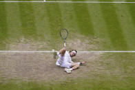Russia's Andrey Rublev falls as after attempting a return to Serbia's Novak Djokovic in a men's singles match on day nine of the Wimbledon tennis championships in London, Tuesday, July 11, 2023. (AP Photo/Alberto Pezzali)
