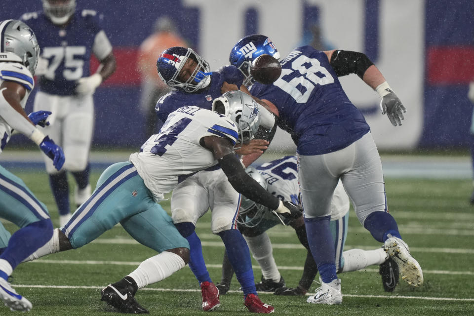 New York Giants' Matt Breida (31), center, fumbles the ball as he is hit during the second half of an NFL football game against the Dallas Cowboys, Sunday, Sept. 10, 2023, in East Rutherford, N.J. (AP Photo/Bryan Woolston)