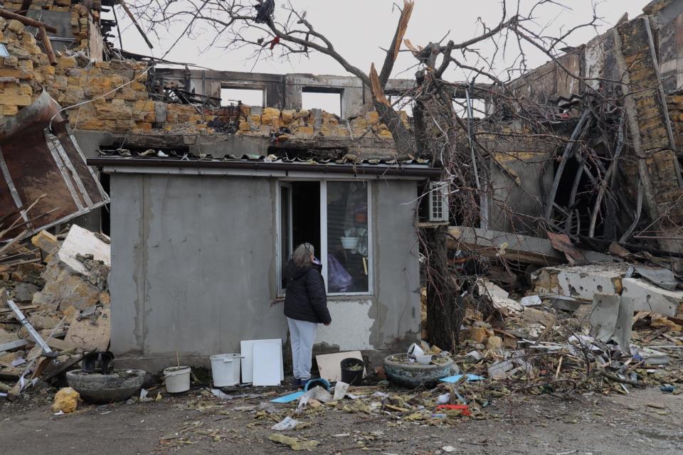 PHOTO: Night watchwoman Olena takes her belongings out of a control point building damaged as a result of a drone attack on a garment factory in Odesa on February 23, 2024, amid the Russian invasion of Ukraine. (Oleksandr Gimanov/AFP via Getty Images)