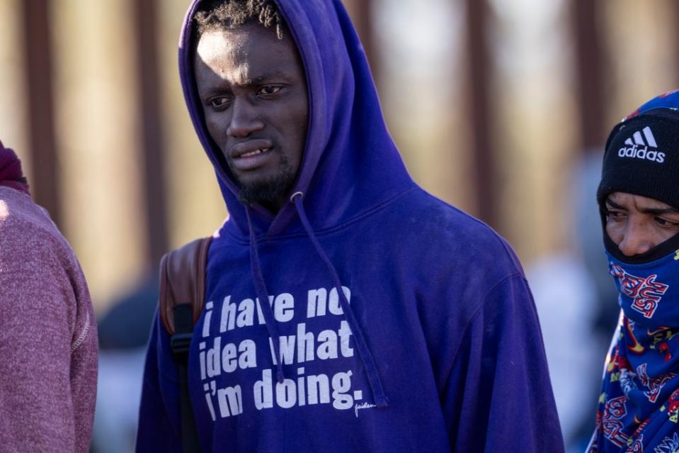 LUKEVILLE, ARIZONA – DECEMBER 05: An immigrant from the west African country of Mauritania waits to be processed by U.S. border authorities on December 05, 2023 in Lukeville, Arizona. A surge of immigrants passing through openings in the border wall cut by smugglers has overwhelmed U.S. immigration officials, causing them to shut down the U.S.-Mexico port of entry in Lukeville, so that officers can help process the new arrivals. (Photo by John Moore/Getty Images)