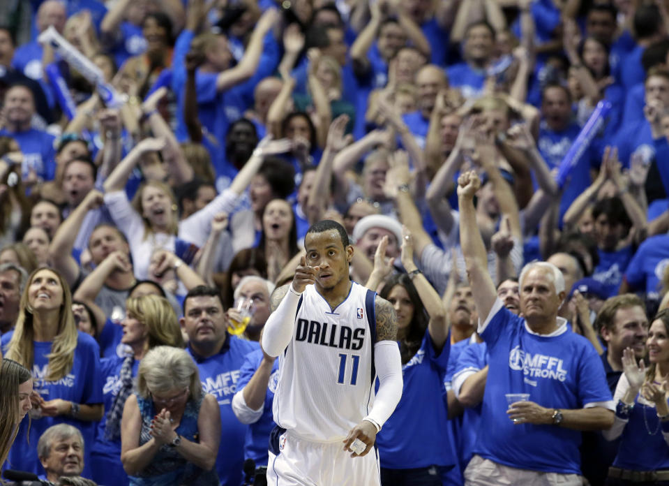 Fans cheer as Dallas Mavericks' Monta Ellis (11) celebrates after scoring and being fouled by the San Antonio Spurs in the second half of Game 6 of an NBA basketball first-round playoff series on Friday, May 2, 2014, in Dallas. The Mavericks won 113-111. (AP Photo/Tony Gutierrez)