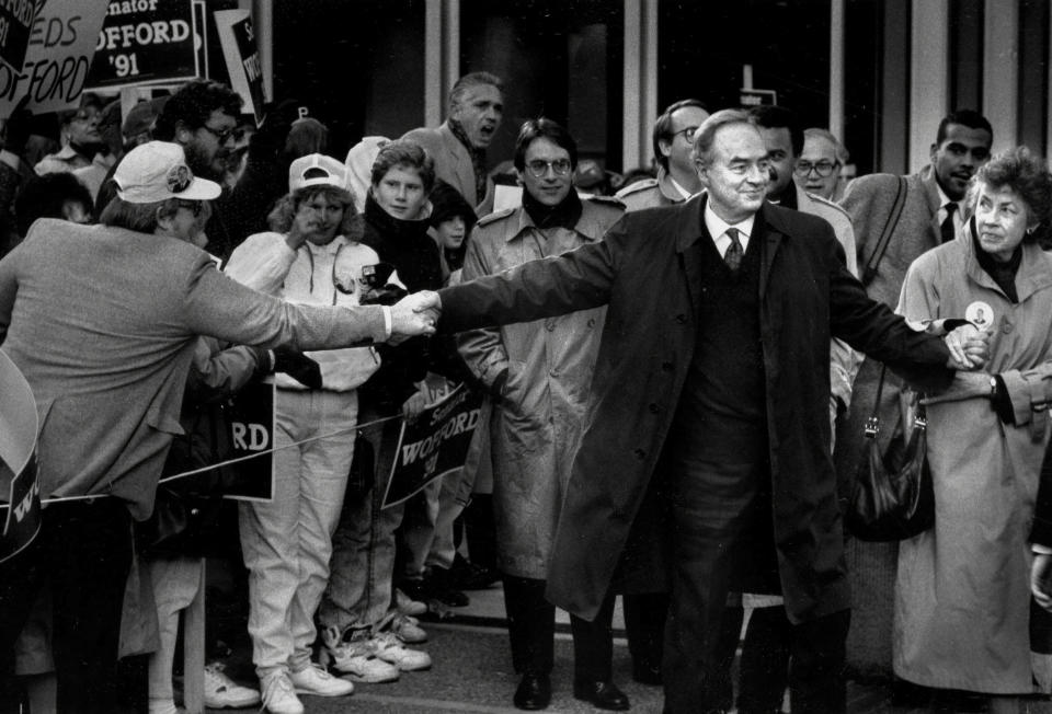 In this Nov. 4, 1991, photo, Sen. Harris Wofford, D-Pa., is pulled in two directions by a supporter and his wife, Clare, at a rally in Pittsburgh. Former Pennsylvania Sen. Harris Wofford died in the hospital late Monday night, Jan. 21, 2019, of complications from a fall Saturday in his Washington apartment, his son, Daniel Wofford, said. He was 92. (Al Fuchs/Pittsburgh Post-Gazette via AP)