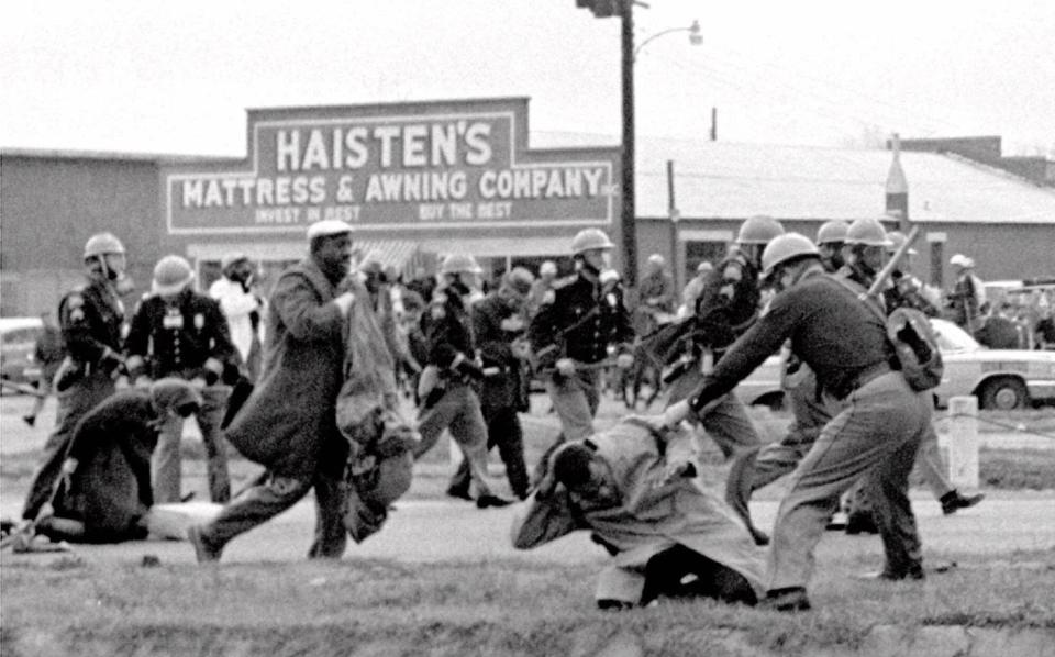 A young John Lewis led the 1965 march across the Edmund Pettus bridge, which was broken up by Alabama state troopers who assaulted Lewis and other demonstrators with nightsticks, clubs and whips.